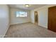 Bright bedroom with carpet flooring and access to bathroom at 5708 W Belmont Ave, Glendale, AZ 85301