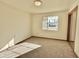 Bright bedroom with large window and neutral carpeting at 5708 W Belmont Ave, Glendale, AZ 85301