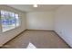 Bedroom featuring a large window and carpet flooring at 5708 W Belmont Ave, Glendale, AZ 85301