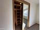 Spacious bedroom closet with wood shelving and mirrored sliding doors at 5708 W Belmont Ave, Glendale, AZ 85301