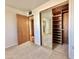 Mirrored closet doors and wood shelving in bedroom at 5708 W Belmont Ave, Glendale, AZ 85301