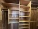 Large walk-in closet with wood shelving and hanging rod at 5708 W Belmont Ave, Glendale, AZ 85301