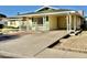 Front view of a yellow house with a covered porch at 5708 W Belmont Ave, Glendale, AZ 85301