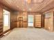 Gathering room with wood paneling, built-in shelving, and fireplace at 5708 W Belmont Ave, Glendale, AZ 85301