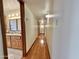 Long hallway with hardwood floors and bathroom access at 5708 W Belmont Ave, Glendale, AZ 85301