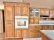 Oak kitchen cabinets with built-in oven and granite countertop at 5708 W Belmont Ave, Glendale, AZ 85301