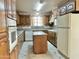 Spacious kitchen with dark wood cabinets and an island at 5708 W Belmont Ave, Glendale, AZ 85301