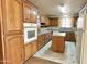 Bright kitchen with oak cabinets, built-in oven, and granite countertops at 5708 W Belmont Ave, Glendale, AZ 85301