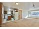 Open kitchen with wood cabinets, an island, and a view of the living room at 5708 W Belmont Ave, Glendale, AZ 85301