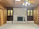 Living room with brick fireplace and wood-paneled walls at 5708 W Belmont Ave, Glendale, AZ 85301