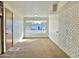 Bright living room with a large window and brick accent wall at 5708 W Belmont Ave, Glendale, AZ 85301