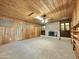 Large living room with wood walls, a fireplace, and built-in shelving at 5708 W Belmont Ave, Glendale, AZ 85301