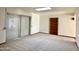 Living room with carpet, sliding doors to patio, and skylight at 5708 W Belmont Ave, Glendale, AZ 85301