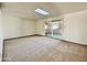 Living room with carpet, sliding doors to patio, and skylight at 5708 W Belmont Ave, Glendale, AZ 85301