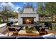 Outdoor patio with fireplace, seating area, and lush landscaping at 6602 E Lafayette Blvd, Scottsdale, AZ 85251