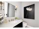 Elegant powder room with marble vanity and statement art at 6602 E Lafayette Blvd, Scottsdale, AZ 85251