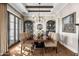 Elegant dining room with hardwood floors, large table, and statement chandelier at 6602 E Lafayette Blvd, Scottsdale, AZ 85251