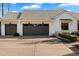 Three-car garage with dark gray doors and white brick exterior at 6602 E Lafayette Blvd, Scottsdale, AZ 85251