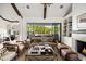 Living area with sliding glass doors opening to backyard, fireplace, and comfy furniture at 6602 E Lafayette Blvd, Scottsdale, AZ 85251