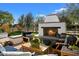 Outdoor seating area with a brick fireplace and lush landscaping at 6602 E Lafayette Blvd, Scottsdale, AZ 85251