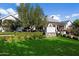 Landscaped side yard with lush green grass and mature trees at 6602 E Lafayette Blvd, Scottsdale, AZ 85251