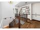 Upstairs hall with built-in shelving and hardwood floors at 6602 E Lafayette Blvd, Scottsdale, AZ 85251