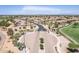 Community entrance with guard gate and surrounding homes, golf course, and mountains at 6616 S Bridal Vail Dr, Gilbert, AZ 85298