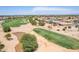 Aerial view showcasing a golf course, water features, and residential homes at 6616 S Bridal Vail Dr, Gilbert, AZ 85298