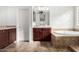 Bathroom with soaking tub, double vanity, and separate shower at 6616 S Bridal Vail Dr, Gilbert, AZ 85298