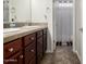 Double sink bathroom with dark wood cabinets at 6616 S Bridal Vail Dr, Gilbert, AZ 85298