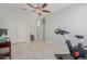 Spacious bedroom with an exercise bike and ceiling fan at 6616 S Bridal Vail Dr, Gilbert, AZ 85298