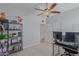 Bedroom with a desk, shelving, and ceiling fan at 6616 S Bridal Vail Dr, Gilbert, AZ 85298