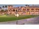 Luxury clubhouse with Spanish architecture, manicured lawn, and golf cart at 6616 S Bridal Vail Dr, Gilbert, AZ 85298