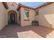 Elegant entryway with wrought iron door and brick paved courtyard at 6616 S Bridal Vail Dr, Gilbert, AZ 85298