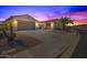 Attractive two-story home with a three-car garage and palm trees in the front at 6616 S Bridal Vail Dr, Gilbert, AZ 85298