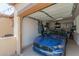 Garage with blue car and built in shelving at 6616 S Bridal Vail Dr, Gilbert, AZ 85298