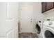 Laundry room with washer, dryer, and storage cabinets at 6616 S Bridal Vail Dr, Gilbert, AZ 85298