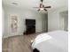 Main bedroom with large TV, ceiling fan, and private door access at 6616 S Bridal Vail Dr, Gilbert, AZ 85298