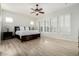 Large main bedroom with ceiling fan and wood flooring at 6616 S Bridal Vail Dr, Gilbert, AZ 85298