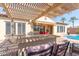 Outdoor kitchen with pergola and seating area at 6616 S Bridal Vail Dr, Gilbert, AZ 85298