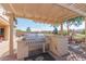 Outdoor kitchen with stainless steel grill and pergola at 6616 S Bridal Vail Dr, Gilbert, AZ 85298