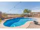 Inviting kidney-shaped pool with a relaxing patio area at 6616 S Bridal Vail Dr, Gilbert, AZ 85298