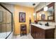 Updated bathroom with a shower/tub combo, vanity with granite countertop, and decorative tile at 7354 E San Miguel Ave, Scottsdale, AZ 85250