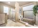 Luxurious bathroom featuring a walk-in shower, soaking tub, and elegant tilework at 7354 E San Miguel Ave, Scottsdale, AZ 85250