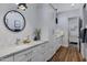 Modern bathroom with double vanity, large mirror, and ample storage at 7483 S Loback Ct, Queen Creek, AZ 85142