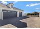 Three-car garage with paver driveway and gated entry at 7483 S Loback Ct, Queen Creek, AZ 85142