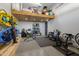 Well-equipped garage gym with exercise equipment and storage at 7483 S Loback Ct, Queen Creek, AZ 85142