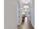 Bright hallway with hardwood floors and elegant light fixtures at 7483 S Loback Ct, Queen Creek, AZ 85142