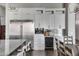 Modern kitchen with stainless steel appliances and white cabinets at 7483 S Loback Ct, Queen Creek, AZ 85142