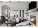 Elegant living room with a fireplace and built-in shelving at 7483 S Loback Ct, Queen Creek, AZ 85142